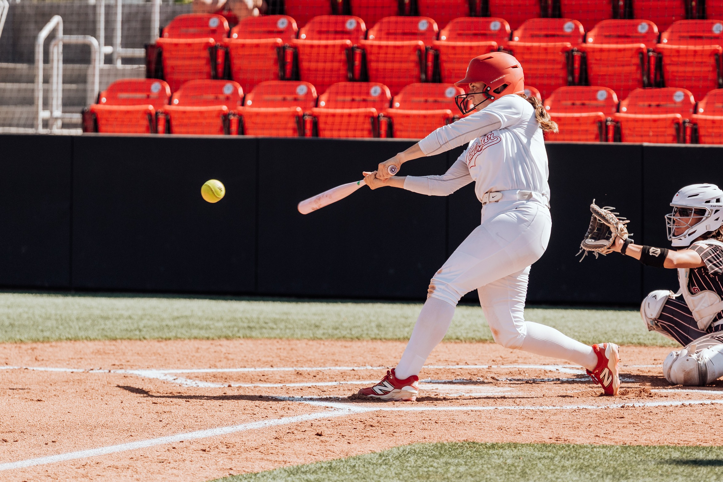 Alexis Huey hits a home run during a home game. 