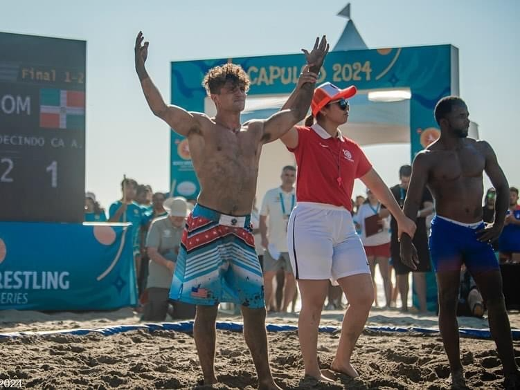 A group of men on a beach Description automatically generated